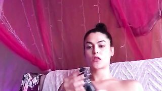 Soloing young tranny with a beautiful face rubs her dick in the bedroom